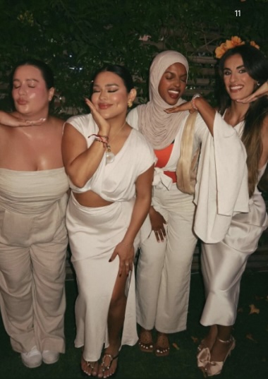 Creators dressed in neutral-toned outfits posing together at an Ulta Beauty community event during the Ulta Beauty Collective campaign.